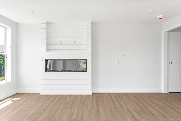 a view of a small space with wooden floor and a window