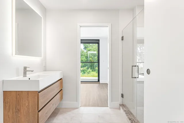 a bathroom with a sink a mirror and a shower