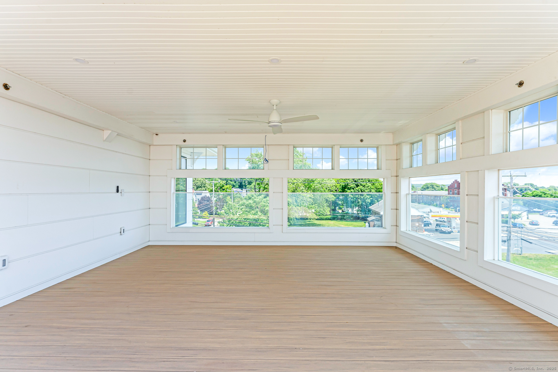 32 Broadway Avenue Stonington, CT 06355 - Photo 9 of 32 a view of a big room with wooden floor and windows