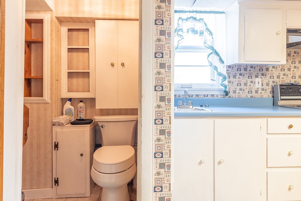 224 Palmer Road Monson, MA 01057 - Photo 24 of 40 a bathroom with a granite countertop toilet and a sink
