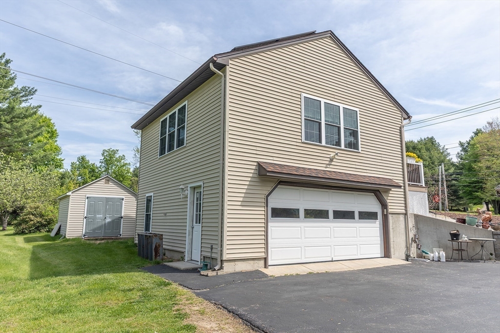 224 Palmer Road Monson, MA 01057 - Photo 31 of 40 a front view of a house with a garden and deck