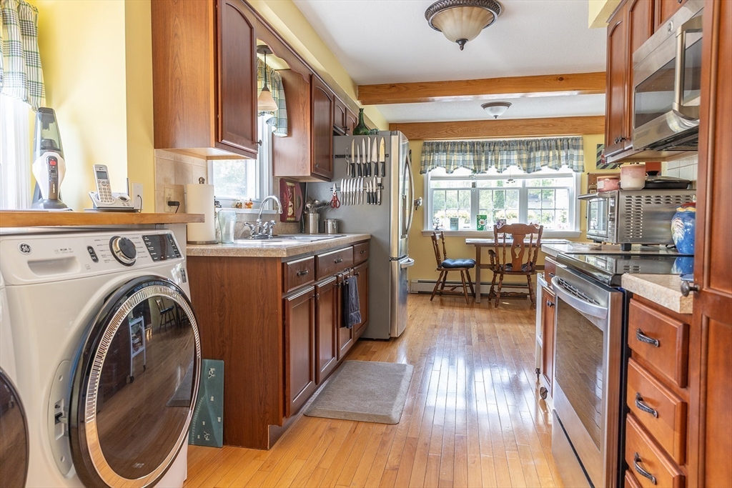 224 Palmer Road Monson, MA 01057 - Photo 5 of 40 a view of a kitchen with a large window and wooden floor