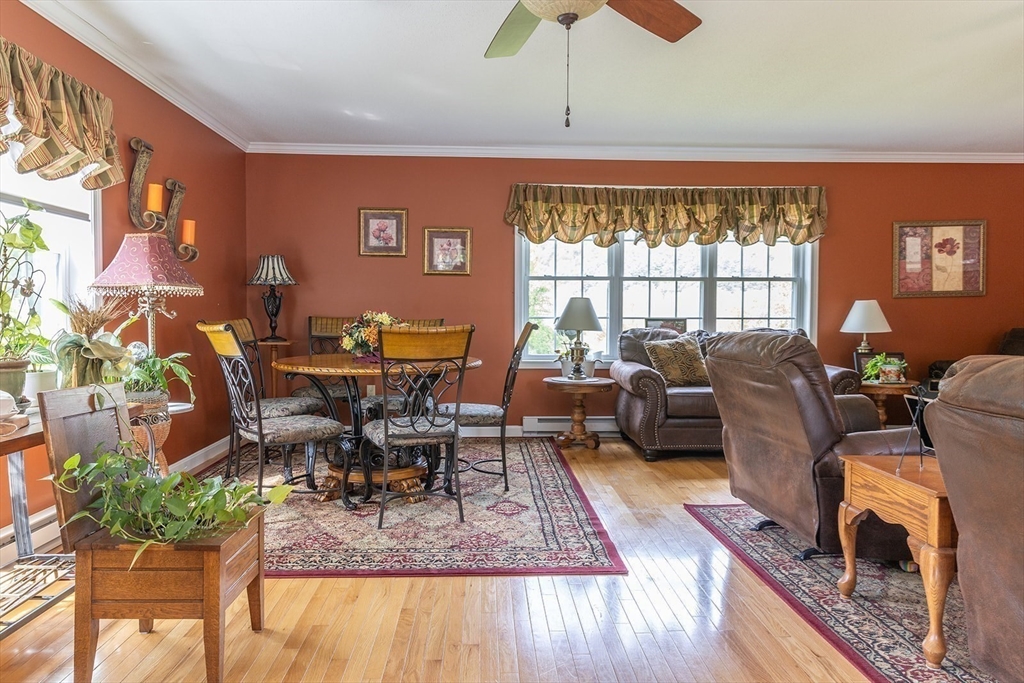 224 Palmer Road Monson, MA 01057 - Photo 8 of 40 a view of a dining room with furniture a chandelier and wooden floor