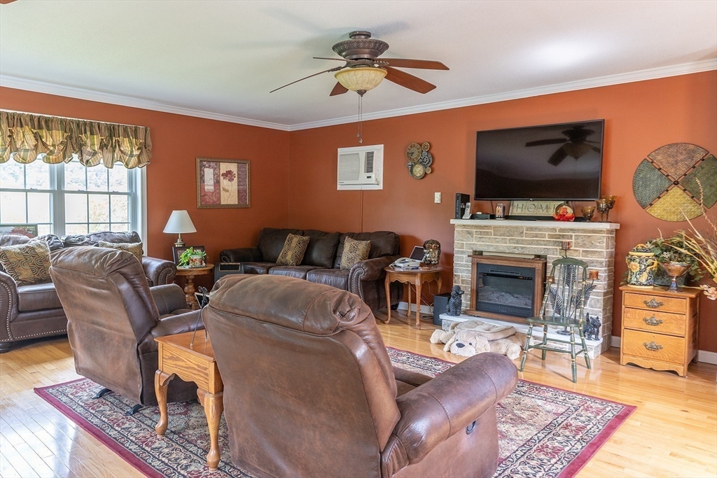 224 Palmer Road Monson, MA 01057 - Photo 9 of 40 a living room with furniture a flat screen tv and a fireplace