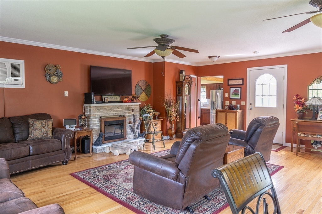 224 Palmer Road Monson, MA 01057 - Photo 10 of 40 a living room with furniture a flat screen tv and a fireplace