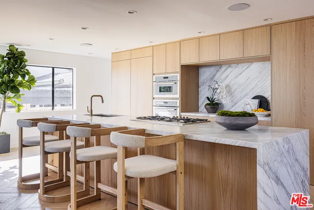 a kitchen with stainless steel appliances granite countertop a sink and a stove