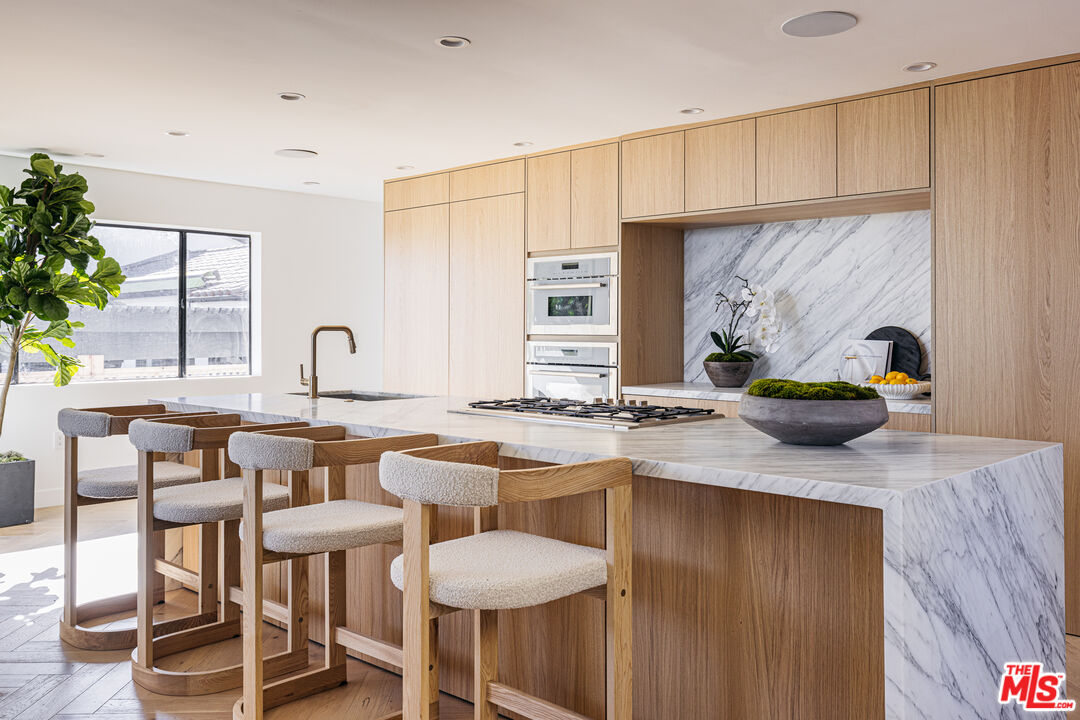7866 Fareholm Drive Los Angeles, CA 90046 - Photo 1 of 27 a kitchen with stainless steel appliances granite countertop a sink and a stove