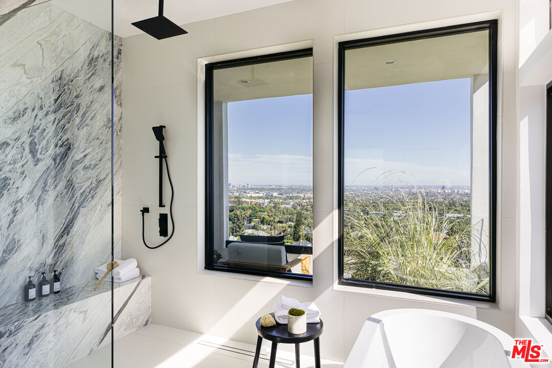 7866 Fareholm Drive Los Angeles, CA 90046 - Photo 14 of 27 a bathroom with a tub and a shower