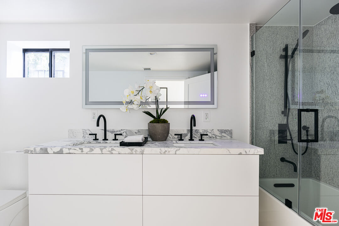 7866 Fareholm Drive Los Angeles, CA 90046 - Photo 17 of 27 a bathroom with a sink and a mirror