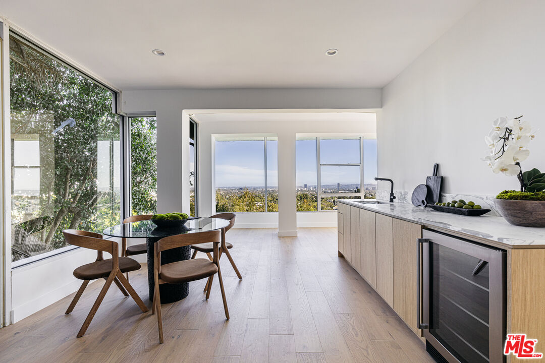 7866 Fareholm Drive Los Angeles, CA 90046 - Photo 19 of 27 a kitchen with sink cabinets and wooden floor