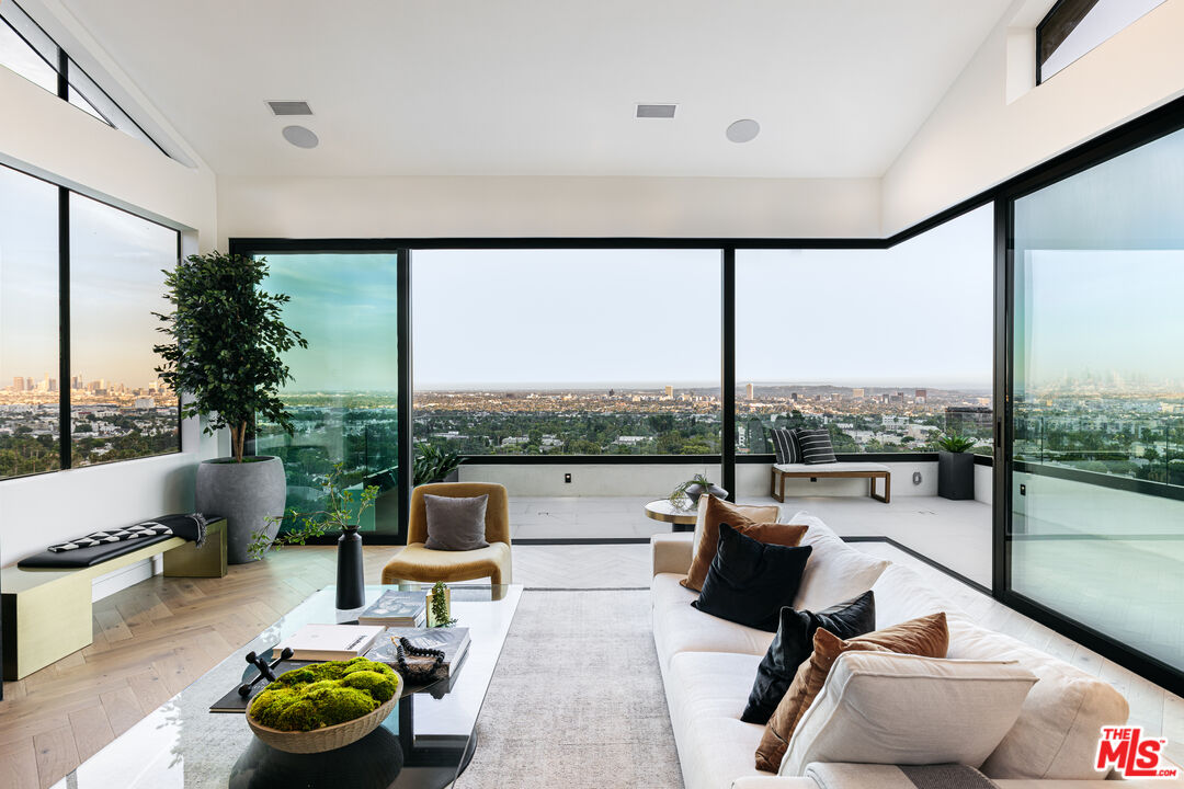 7866 Fareholm Drive Los Angeles, CA 90046 - Photo 3 of 27 a living room with patio furniture and a floor to ceiling window