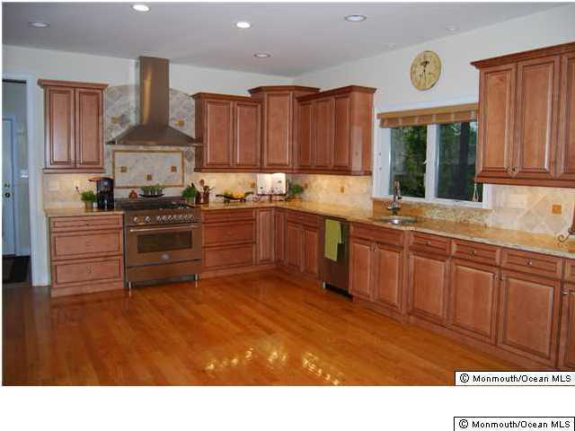 417 Ely Road Neptune Township, NJ 07753 - Photo 3 of 3 a kitchen with stainless steel appliances granite countertop a sink stove and refrigerator