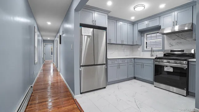 a kitchen with stainless steel appliances a refrigerator sink and cabinets