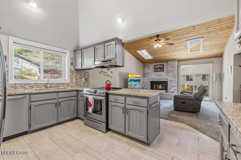 675 College Drive Reno, NV 89503 - Photo 9 of 30 a kitchen that has a lot of cabinets in it and stainless steel appliances
