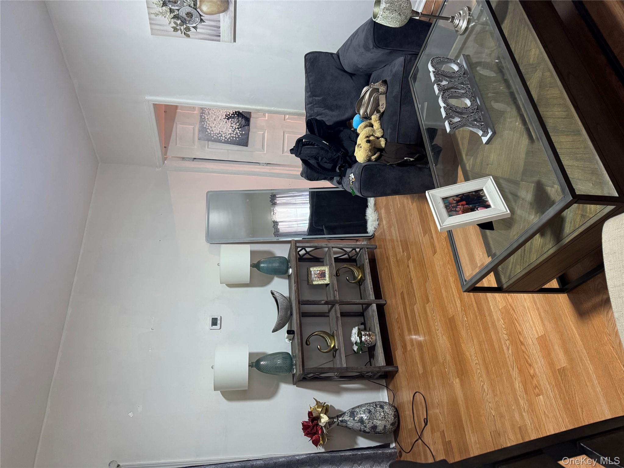 94-13 116th Street Queens, NY 11419 - Photo 12 of 34 Living room featuring wood finished floors