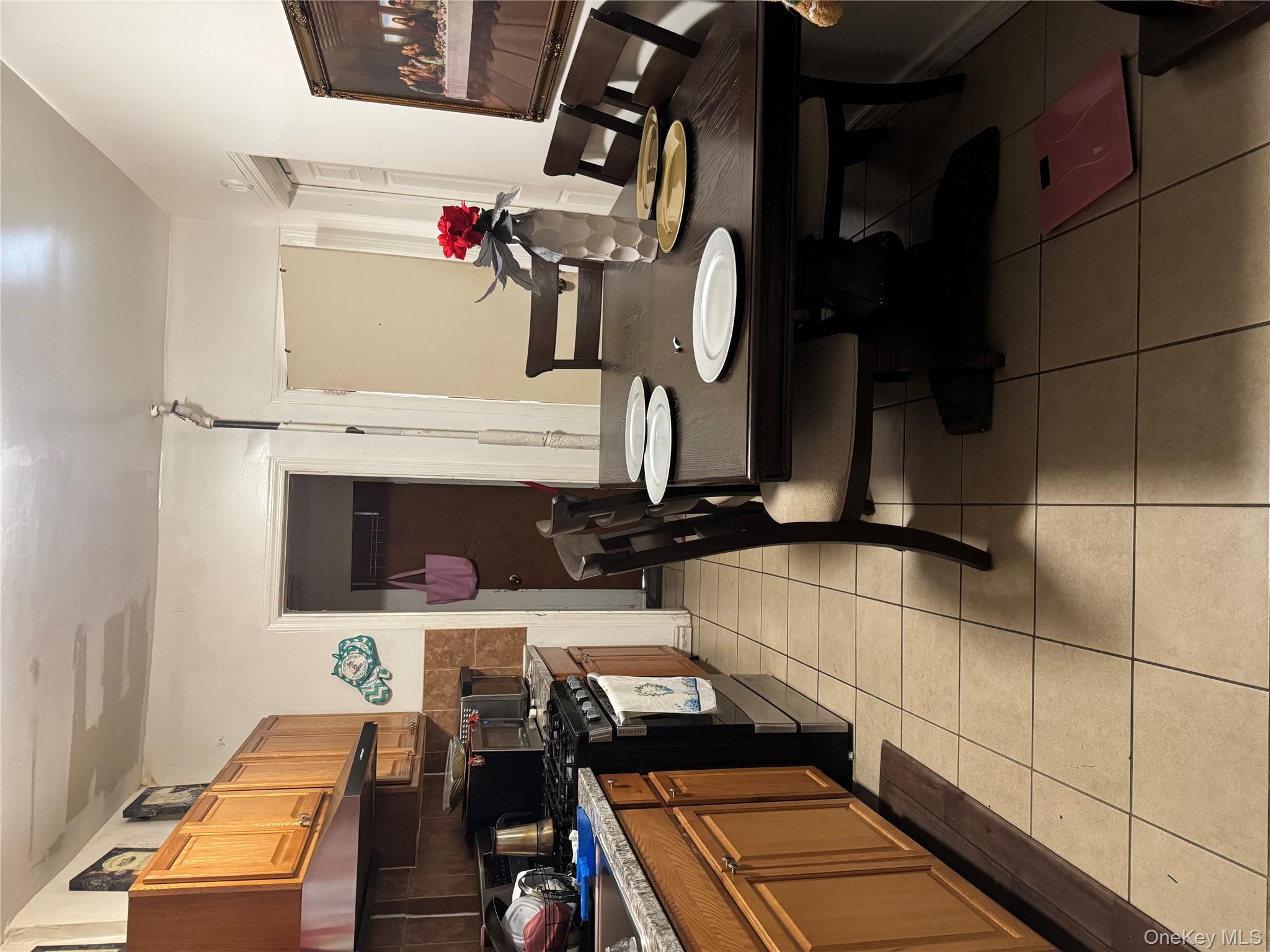 94-13 116th Street Queens, NY 11419 - Photo 14 of 34 Dining area with light tile patterned floors