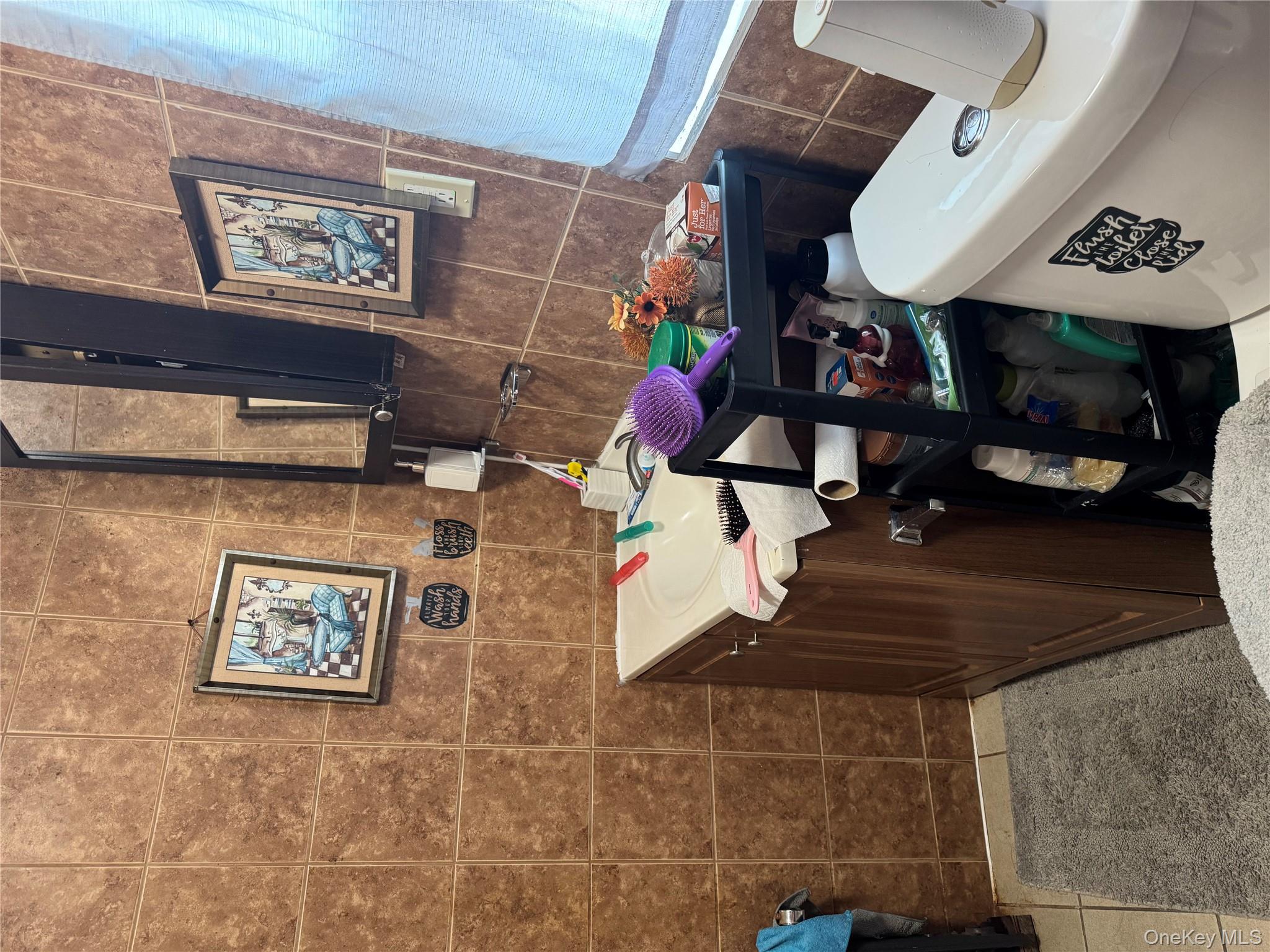 94-13 116th Street Queens, NY 11419 - Photo 18 of 34 Bathroom with tile walls, vanity, and light tile patterned floors