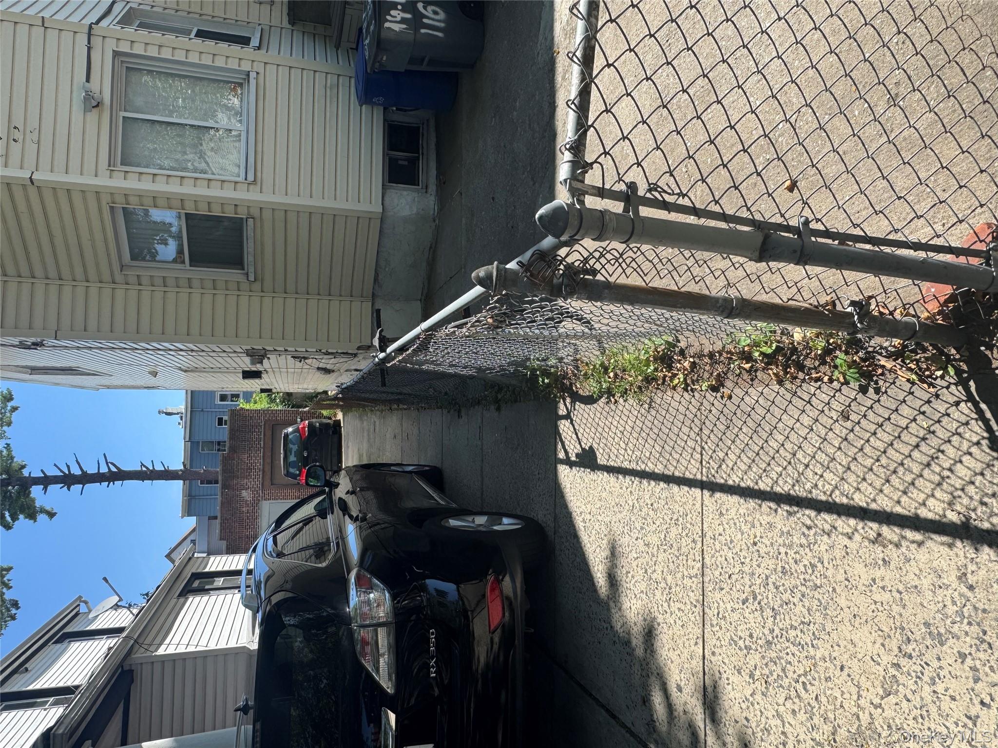 94-13 116th Street Queens, NY 11419 - Photo 2 of 34 View of side of property featuring an outbuilding