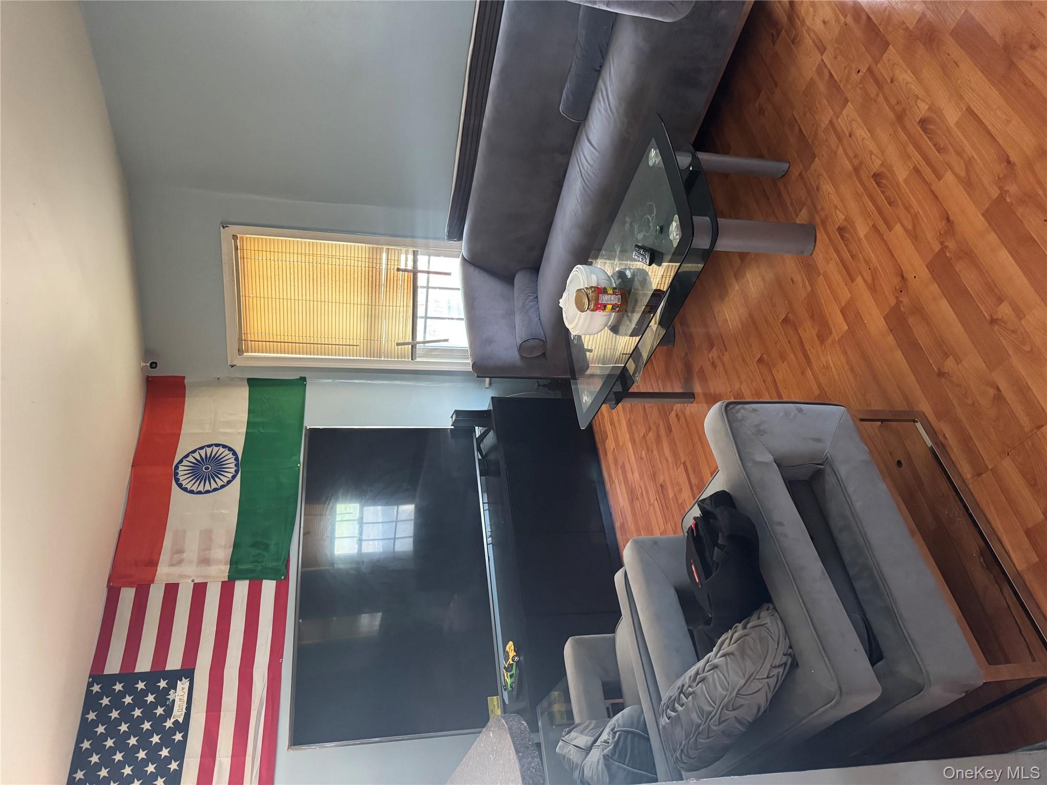 94-13 116th Street Queens, NY 11419 - Photo 29 of 34 Living room featuring wood finished floors