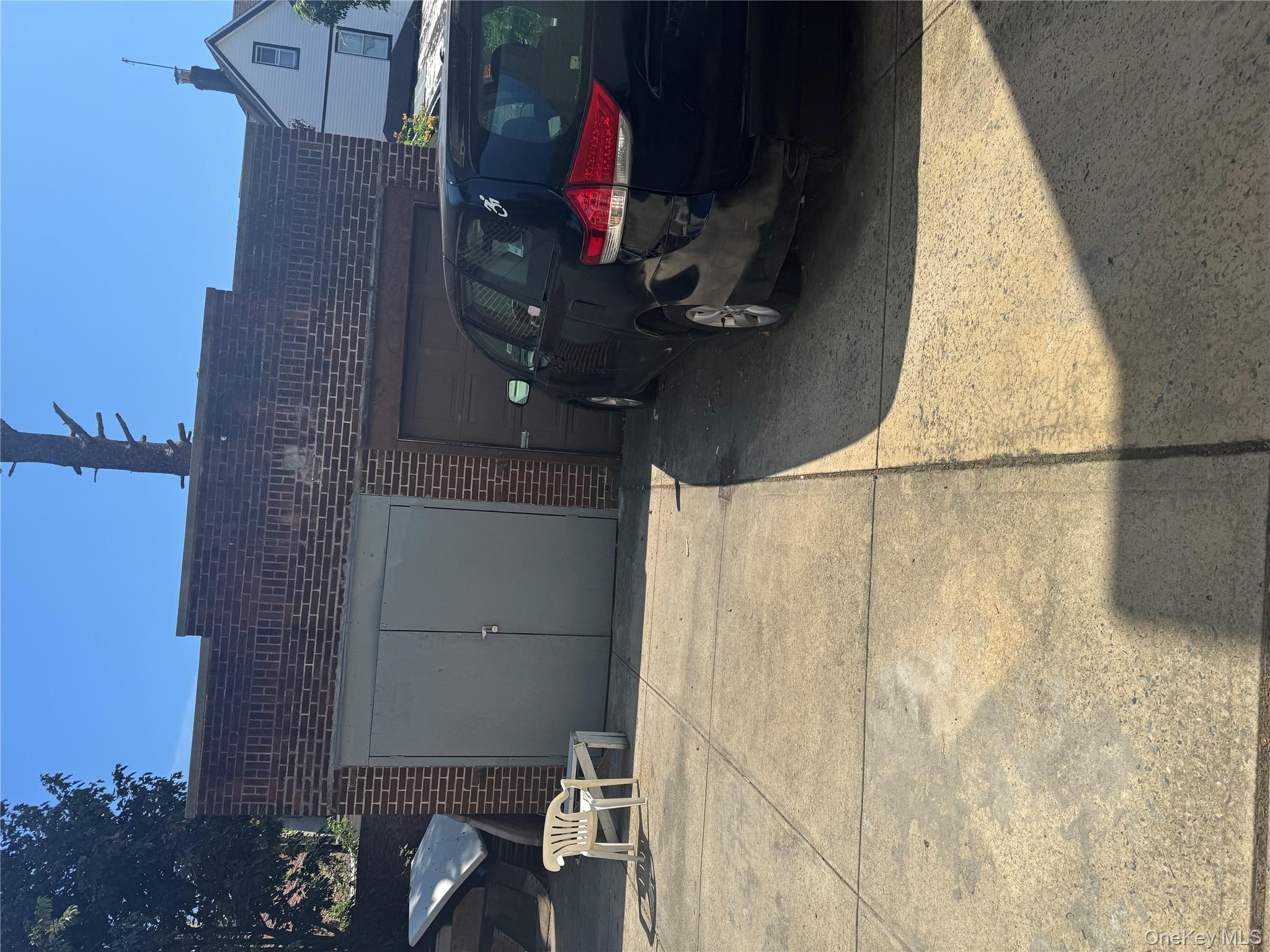 94-13 116th Street Queens, NY 11419 - Photo 4 of 34 Rear view of house featuring brick siding
