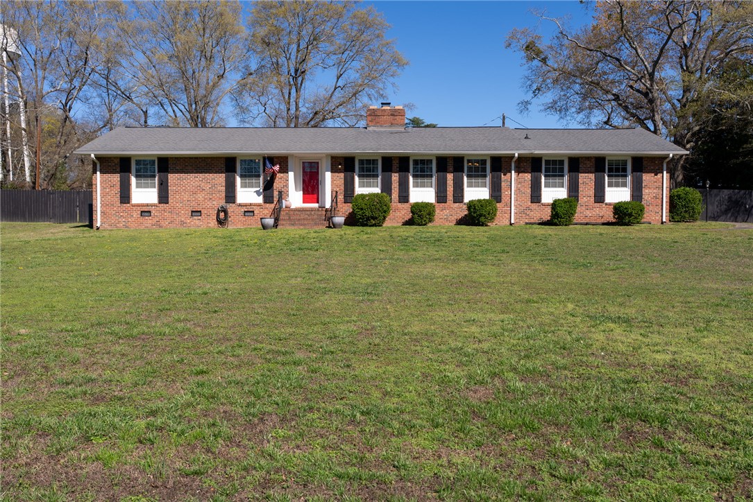 300 Green Street Williamston, SC 29697 - Photo 47 of 47 A charming brick ranch home with a spacious front yard and inviting red door.
