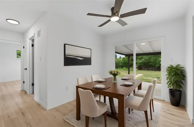 a dining room with furniture window and wooden floor
