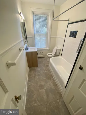 an empty room with windows and cabinet