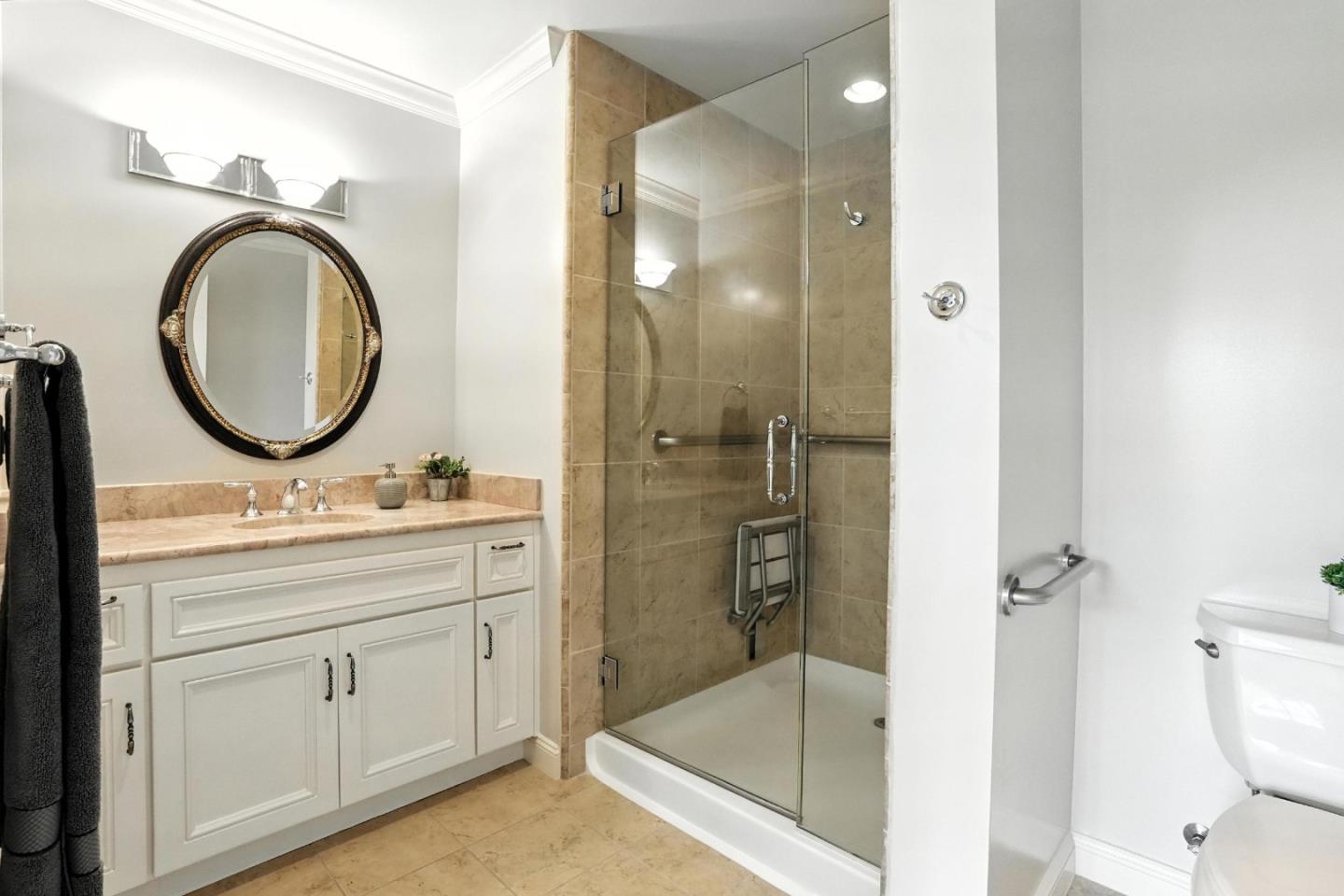 10 Crystal Springs Road, Unit 2414 San Mateo, CA 94402 - Photo 20 of 33 a bathroom with a granite countertop sink mirror vanity and toilet