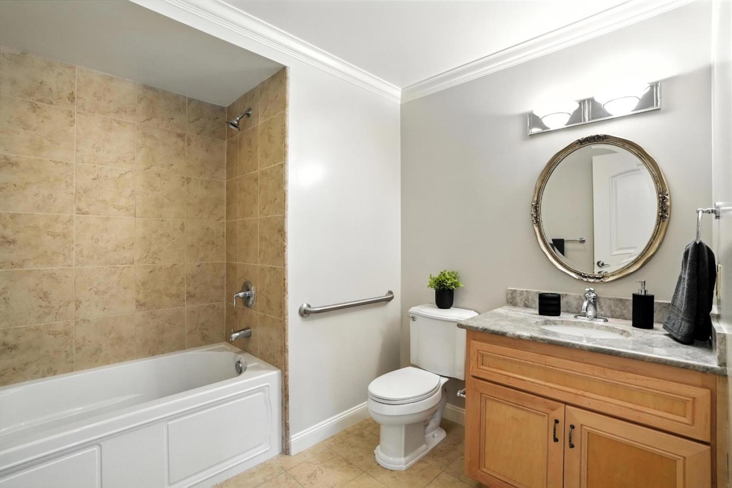 10 Crystal Springs Road, Unit 2414 San Mateo, CA 94402 - Photo 24 of 33 a bathroom with a toilet a sink a mirror a bathtub and shower