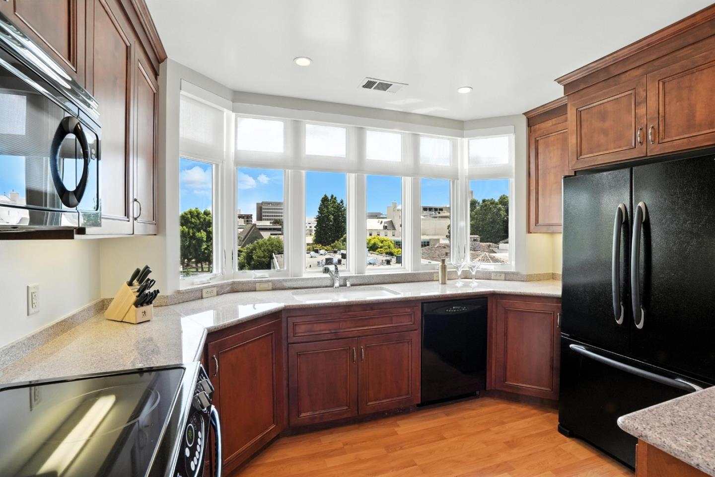 10 Crystal Springs Road, Unit 2414 San Mateo, CA 94402 - Photo 7 of 33 a kitchen with stainless steel appliances granite countertop a sink stove and refrigerator