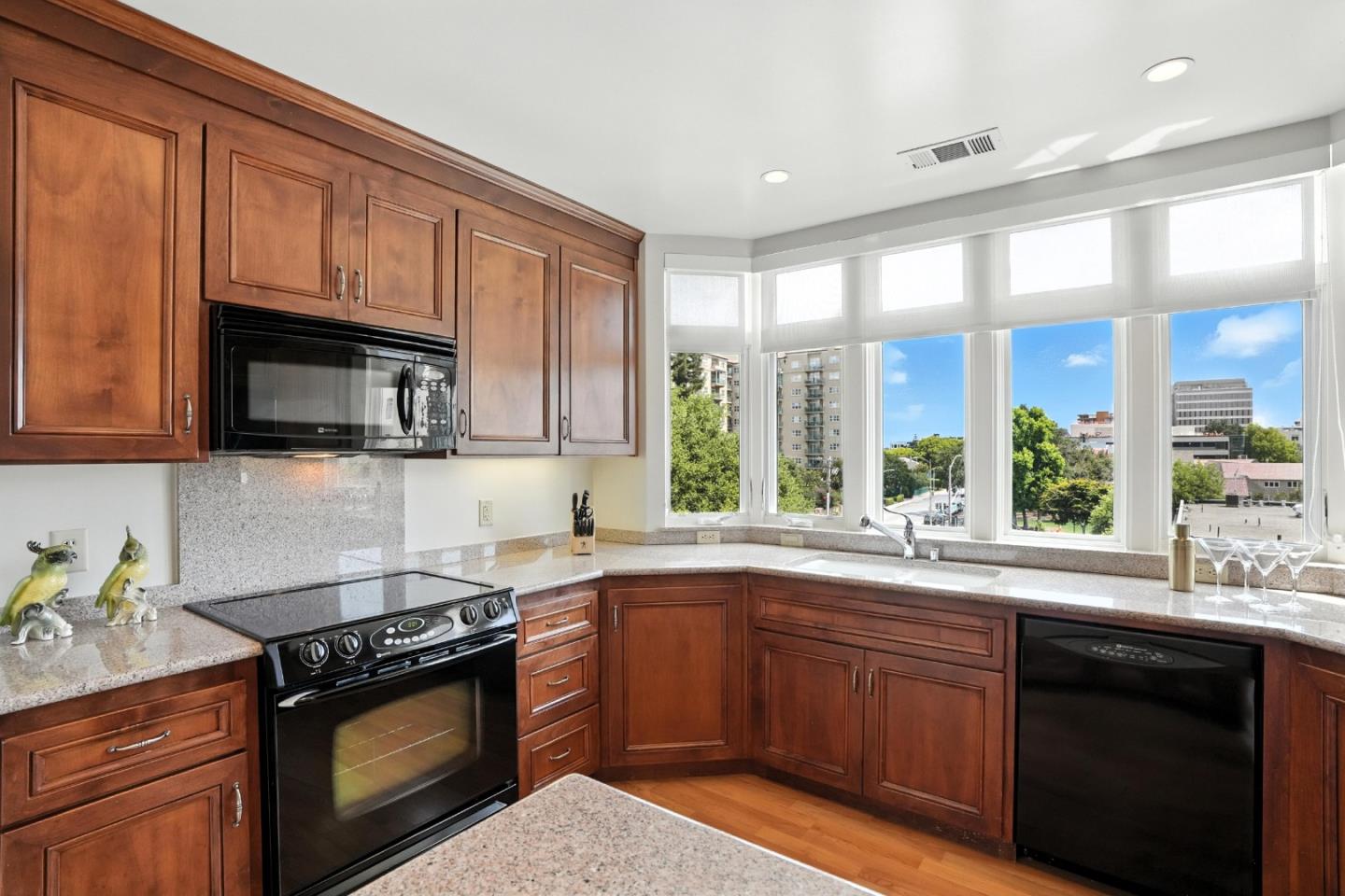 10 Crystal Springs Road, Unit 2414 San Mateo, CA 94402 - Photo 8 of 33 a kitchen with a sink stove top oven and cabinets