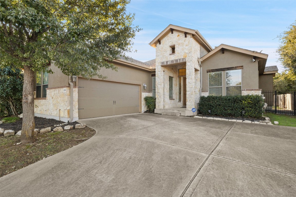 a view of a house with a yard and garage