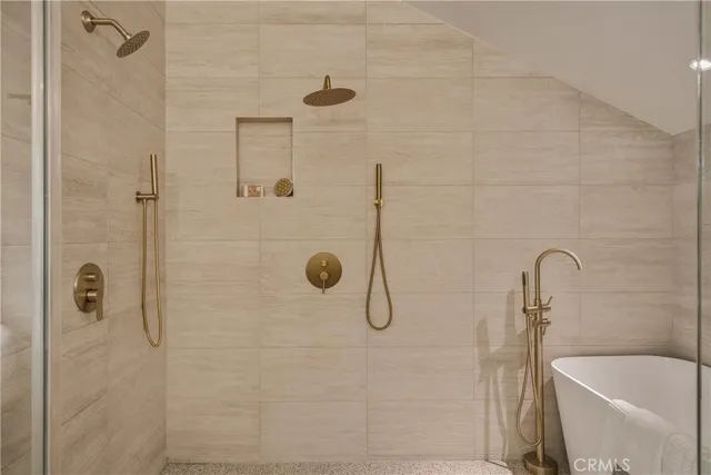 a spacious bedroom with a bed and chandelier