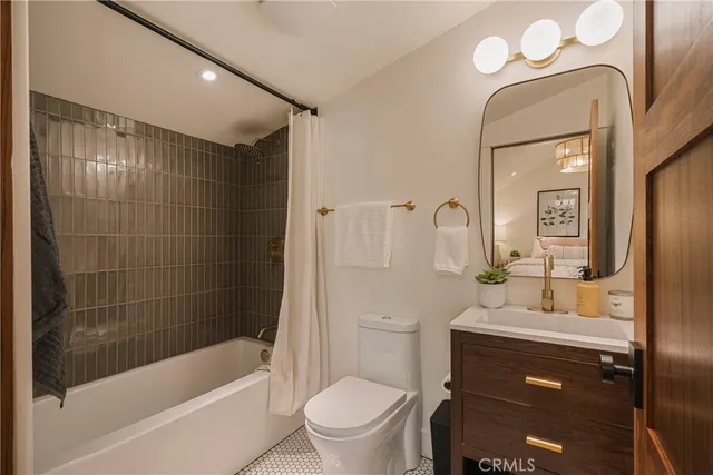 a bedroom with a bed and a ceiling fan