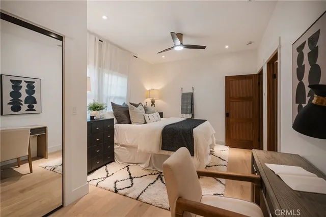 a spacious bedroom with a bed and large windows