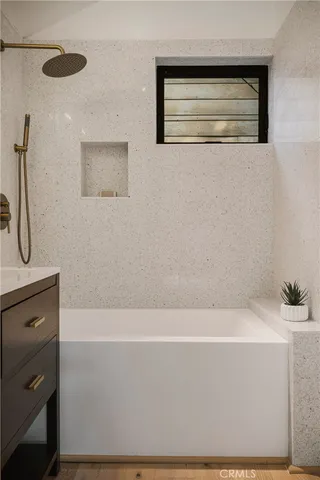 a living room with furniture large window and wooden floor