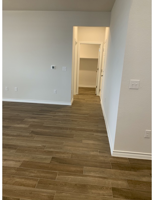 11715 Caithness Way Austin, TX 78653 - Photo 13 of 40 Hall featuring dark wood-type tile flooring and baseboards