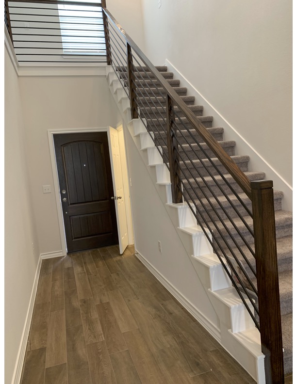 11715 Caithness Way Austin, TX 78653 - Photo 16 of 40 Foyer featuring dark wood-type tile flooring and a high ceiling