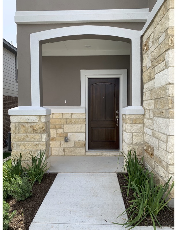 11715 Caithness Way Austin, TX 78653 - Photo 2 of 40 Doorway to property with stone siding