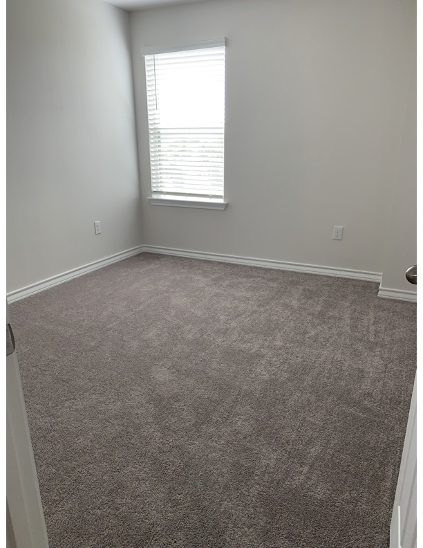 11715 Caithness Way Austin, TX 78653 - Photo 22 of 40 2nd bedroom featuring dark colored carpet and baseboards