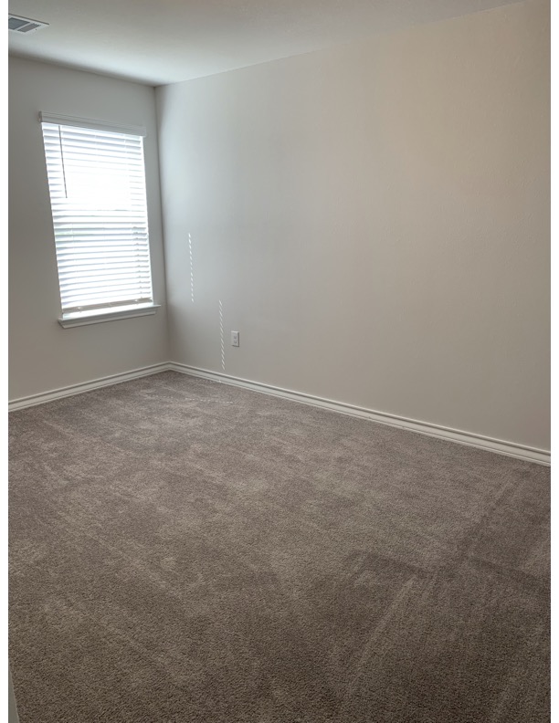 11715 Caithness Way Austin, TX 78653 - Photo 26 of 40 3rd Bedroom featuring dark carpet and baseboards