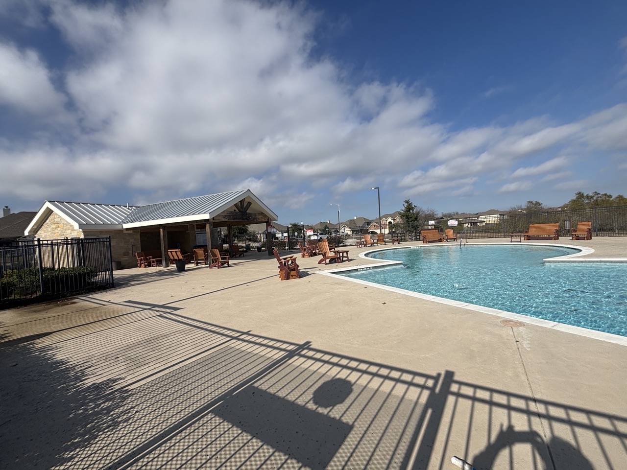 11715 Caithness Way Austin, TX 78653 - Photo 39 of 40 Community pool featuring a patio area and a recreation room with a residential view