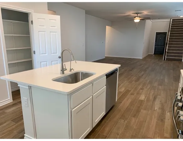 a kitchen that has a sink and a stove in it