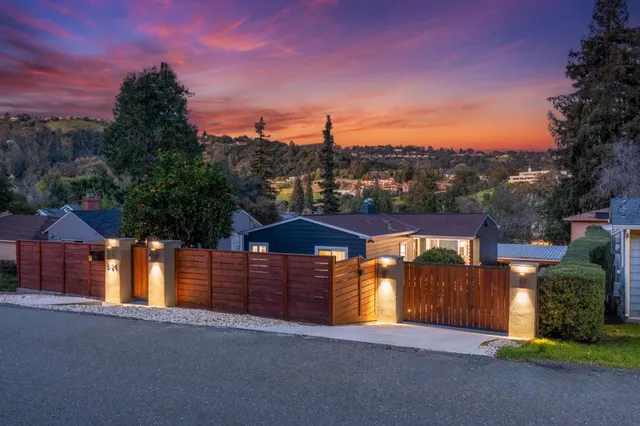 a view of a house with a yard and tree s
