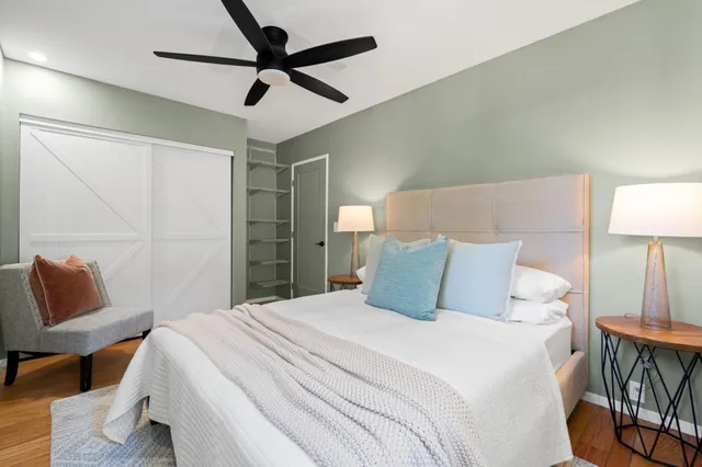 a bedroom with a bed and a lamp