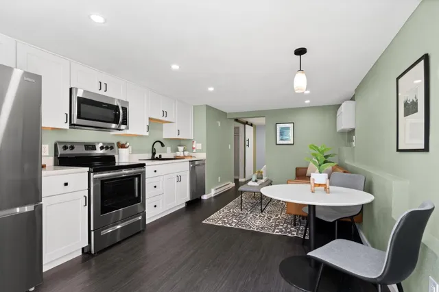 a kitchen with a sink cabinets and wooden floor