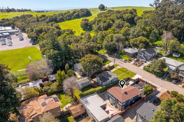 an aerial view of residential houses with outdoor space