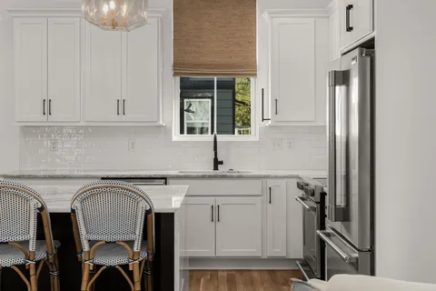 a kitchen with stainless steel appliances granite countertop a sink and cabinets