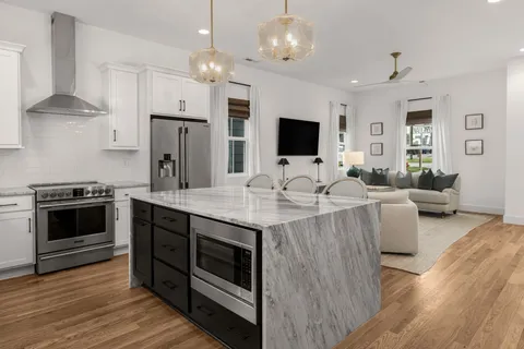 a view of kitchen with sink stove and refrigerator