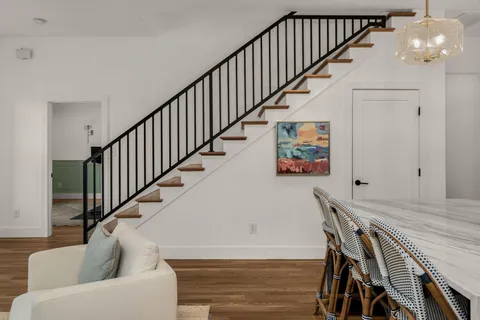 a view of livingroom and dining room with wooden floor and stairs